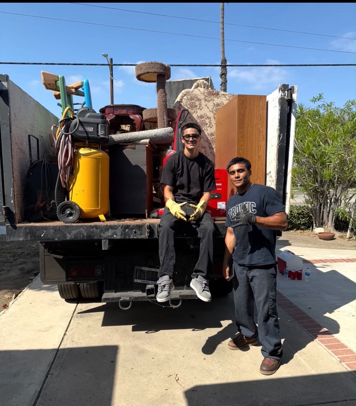 Prolific Services crew with a truck fully loaded with junk and equipment